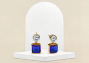 Gold-plated dangle earrings with blue sapphire and cubic zirconia accents